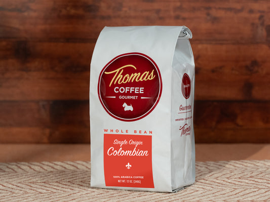 Thomas Coffee Gourmet whole bean Colombian coffee bag on a wooden surface