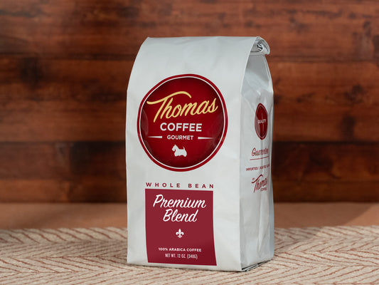 Thomas Coffee whole bean coffee bag on a wooden surface