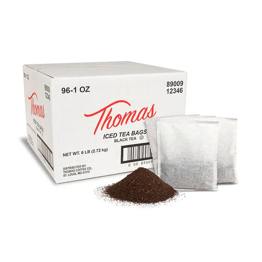A box of Thomas brand iced tea bags next to a pile of loose tea and a tea bag.