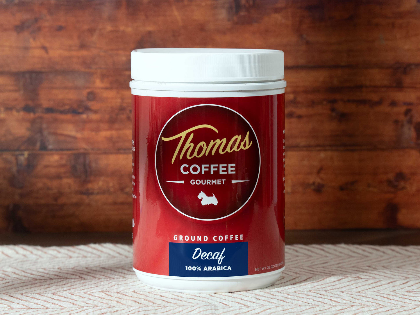Thomas Coffee Gourmet decaffeinated coffee container with a wooden background