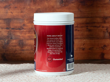 Thomas Coffee Gourmet decaffeinated coffee container with a wooden background