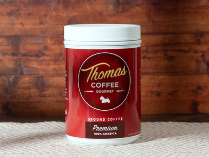 Thomas Coffee Premium Blend container with red label on a wooden background
