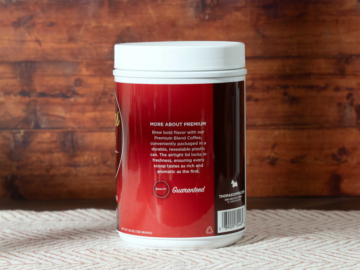 Thomas Coffee Premium Blend container with red label on a wooden background